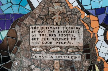 A ceramic mural with the quote "The ultimate tragedy is not the brutality of the bad people but the silence of the good people." - Dr. Martin Luther King