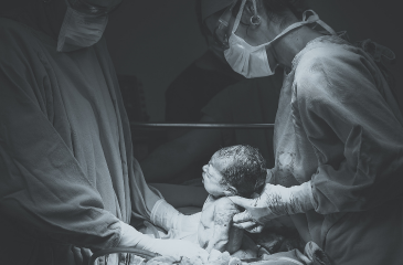 Two doctors delivering a newborn